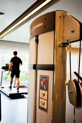 a man is walking on a treadmill in a gym at NEW! Studio Condo in Prisma Residences Pasig in Manila