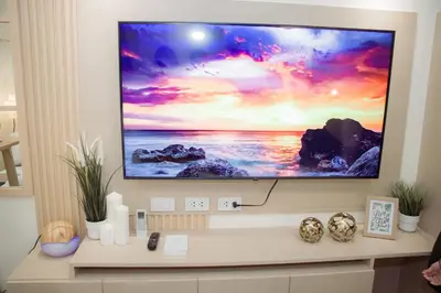 a flat screen tv sitting on a wall at Becca Suite by Crib2GO with Pool View in Manila