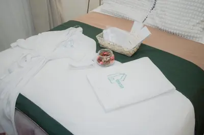 a bed with white towels and a box on it at Becca Suite by Crib2GO with Pool View in Manila