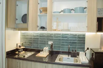 a kitchen with a sink and a counter top at Becca Suite by Crib2GO with Pool View in Manila