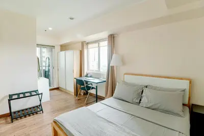 a white bedroom with a bed and a desk at Spacious 2BR at SoMa BGC Near SM Aura and Bonifacio High Street in Manila