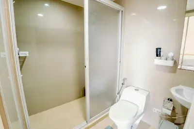 a bathroom with a shower and a toilet and a sink at Spacious 2BR at SoMa BGC Near SM Aura and Bonifacio High Street in Manila