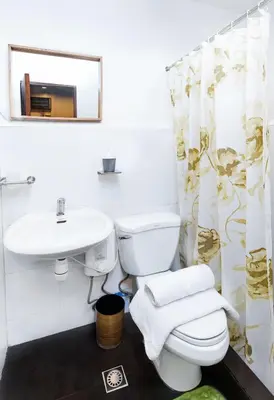 a bathroom with a toilet and a sink at Homey and Cozey Poblacion Makati S01 in Manila