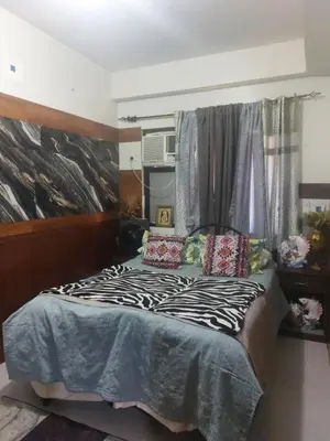 a bedroom with a bed with a zebra blanket at Florida sun estates condo in General Trias
