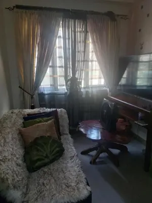 a living room with a couch and a piano at Florida sun estates condo in General Trias