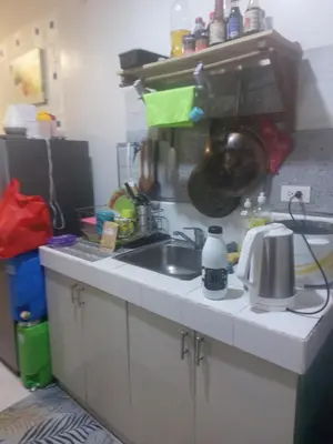 a kitchen counter with a sink and a pot on the wall at Florida sun estates condo in General Trias
