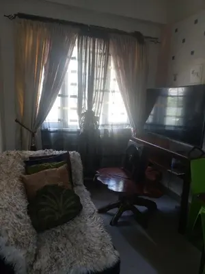 a living room with a couch and a flat screen tv at Florida sun estates condo in General Trias