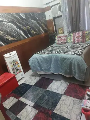 a small bedroom with a bed and a rug at Florida sun estates condo in General Trias