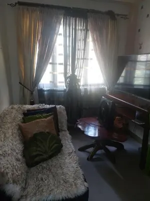 a living room with a bed and a piano at Florida sun estates condo in General Trias