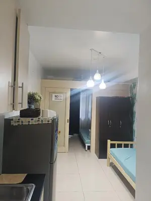 a kitchen with a sink and a kitchen with a bed at SEA RESIDENCES NEAR MALL OF ASIA BY Amigo's place in Manila