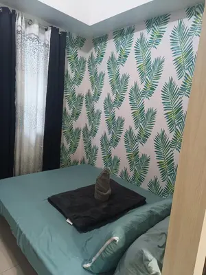 a bedroom with a bed with a hat on it at SEA RESIDENCES NEAR MALL OF ASIA BY Amigo's place in Manila