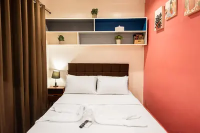 a bedroom with a bed with white towels on it at Homey and Cozey Poblacion Makati S02 in Manila