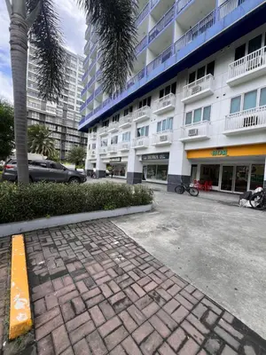 a parking lot in front of a large building at Sea Residences MOA Manila By Paul XIVI in Manila