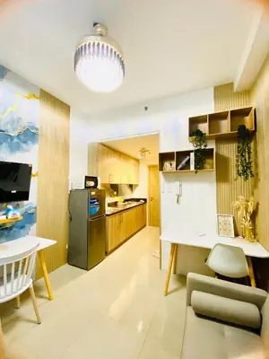a kitchen with a table and a dining room at MOA SHORE - Exxy SUITES in Manila