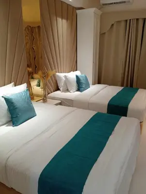 two beds sitting next to each other in a room at Homefort at Lush Residences Makati Unit 1137 in Manila