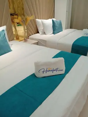 two beds in a hotel room with a towel on the bed at Homefort at Lush Residences Makati Unit 1137 in Manila