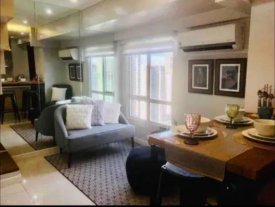 a living room with a couch and a table at Fort Victoria Condominium Tower C in Manila
