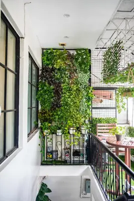 a vertical garden on the side of a balcony at Homey and Cozey Poblacion Makati S03 in Manila