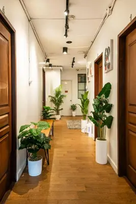 a corridor with potted plants in an office at Homey and Cozey Poblacion Makati S04 in Manila