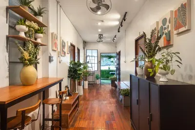 a hallway with a table and chairs and plants at Homey and Cozey Poblacion Makati S04 in Manila