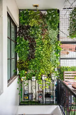 a wall with potted plants on a balcony at Homey and Cozey Poblacion Makati S05 in Manila