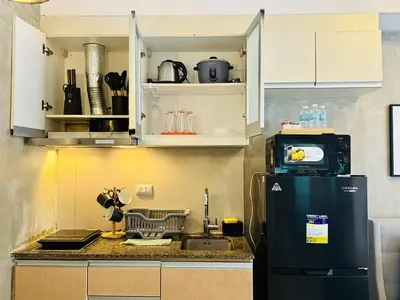 a kitchen with a refrigerator and a microwave at Luxurious Viceroy Residence Walk to Venice Grand Canal in Manila