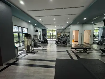 a gym with treadmills and machines in a room at Luxurious Viceroy Residence Walk to Venice Grand Canal in Manila