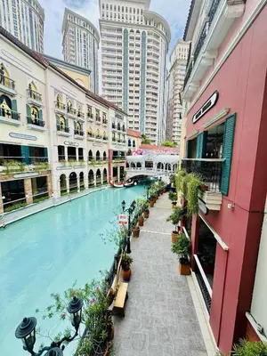 a swimming pool in a city with tall buildings at Luxurious Viceroy Residence Walk to Venice Grand Canal in Manila