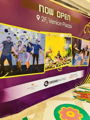 a stage with a picture of a group of people at Luxurious Viceroy Residence Walk to Venice Grand Canal in Manila