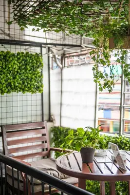 a table with a potted plant on a patio at Homey and Cozey Poblacion Makati S06 in Manila