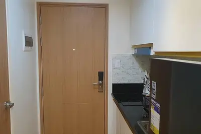 a wooden door in a kitchen next to a counter at Red Residence Makati-Cozy Condo Unit with Balcony in Manila