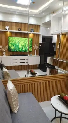 a living room with a couch and a television at Red Residence Makati-Cozy Condo Unit with Balcony in Manila