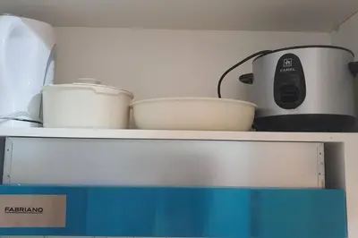 a toaster and bowls on top of a shelf at Red Residence Makati-Cozy Condo Unit with Balcony in Manila