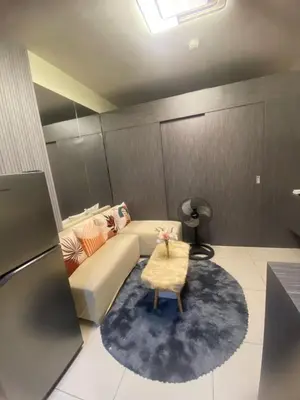 a living room with a couch and a table at Cozy Urban Apartment in Pasay City in Manila