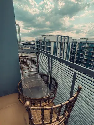 a table on a balcony with a view of a city at One Palm Tree Condominium in Manila