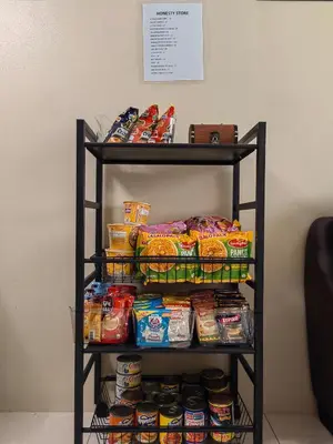 a shelf filled with food and other snacks at One Palm Tree Condominium in Manila