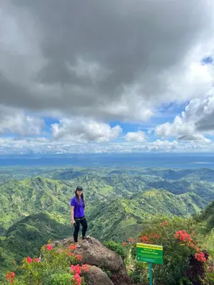 a woman standing on top of a mountain at One Palm Tree Condominium in Manila