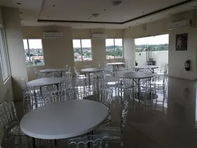 a room with white tables and chairs and windows at Homey Staycation in Silang Cavite! Fullerton Suites Puting Kahoy - near CKS, AUP, PNPA, in Puting Kahoy