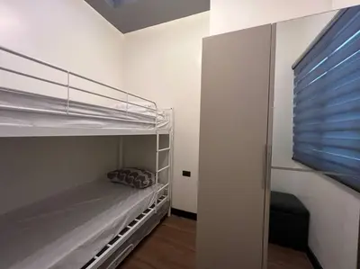 a small bedroom with a bunk bed and a window at Kapitolyo Prisma Residential Condo TCPH21 - NYC Vibes Penthouse with KTV Pool and Balcony with City View Panorama 5 Min Drive to BGC St Lukes and Ortigas - Staycations by SMS in Manila