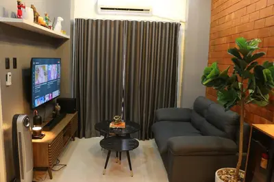 a living room with a couch and a tv at Kapitolyo Prisma Residential Condo TCPH21 - NYC Vibes Penthouse with KTV Pool and Balcony with City View Panorama 5 Min Drive to BGC St Lukes and Ortigas - Staycations by SMS in Manila