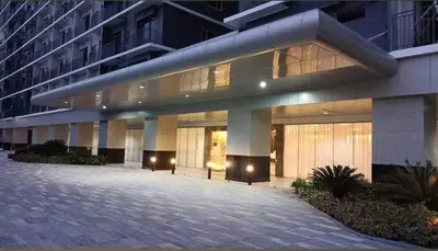 a large building with a courtyard in front of it at LAJ Staycation Shore3 Residences in Manila