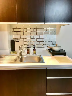 a kitchen with a sink and a counter top at Best Value Stylish Loft Steps from Greenbelt Mall in Manila