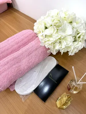 a bouquet of white flowers next to a towel at Cozy Korean Studio Shore 2 Residences in Manila