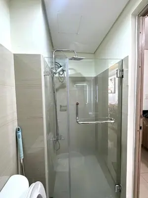 a glass shower in a bathroom with a toilet at Cozy Korean Studio Shore 2 Residences in Manila