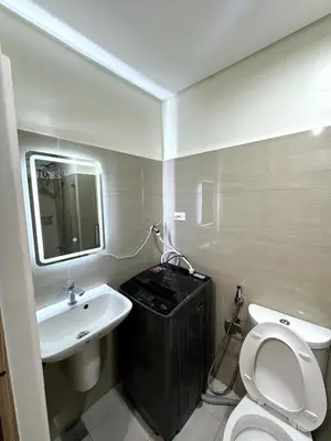 a bathroom with a white toilet and a sink at Cozy Korean Studio Shore 2 Residences in Manila