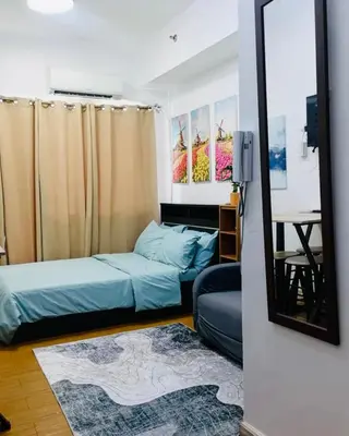 a bedroom with two beds and a mirror at LD Cozy Condo - Grace Residences, Taguig City near BGC in Manila