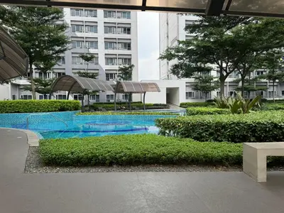 a swimming pool in the middle of a building at LD Cozy Condo - Grace Residences, Taguig City near BGC in Manila