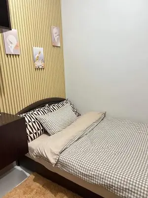 a small bed in a room with at Trina's Suites in Manila