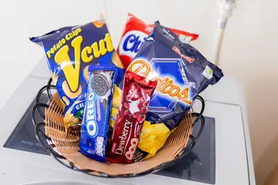 a basket of candy and snacks on a table at LUXX BGC Venice in Manila