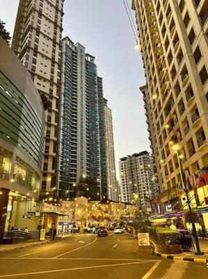a street in a city with tall buildings at Avant at the Fort BGC 1BR Flr to Ceiling Cor Unit with Great View in Manila
